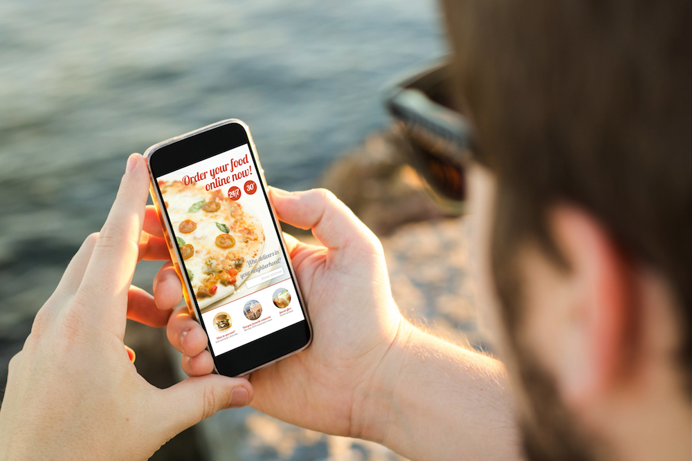 A Man ordering from a restaurant mobile application
