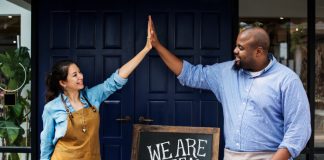 A Step By Step Guide On How To Start A Restaurant Business In India In 2023 A woman and a man high-fiving after successfully starting a restaurant