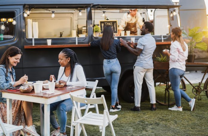 Customers at a food truck ordering meals