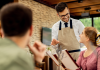 How To Increase Customer Loyalty In Restaurants? Restaurant Server taking order from a woman