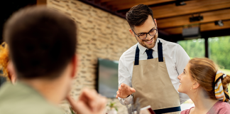 How To Increase Customer Loyalty In Restaurants? Restaurant Server taking order from a woman
