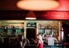 Increasing Restaurant And Bar Profits In 2023 – 9 Effective Ways You Can’t Go Wrong With! Two women sitting at a bar holding their drinks.