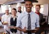 Measuring Restaurant Staff Performance: 6 Ways to Monitor the KPI of Your Restaurant Staff Entire restaurant staff smiling for a kitchen snapshot