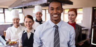 Measuring Restaurant Staff Performance: 6 Ways to Monitor the KPI of Your Restaurant Staff Entire restaurant staff smiling for a kitchen snapshot