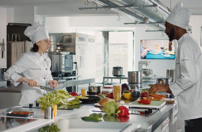 Two chefs cooking in a cloud kitchen.