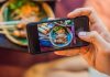 The Complete Guide To Social Media Marketing For Restaurants Restaurant customer taking a picture of food with mobile phone