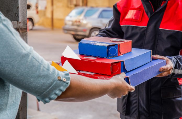 Cloud Kitchen Delivery executive delivering the order at customer's doorstep