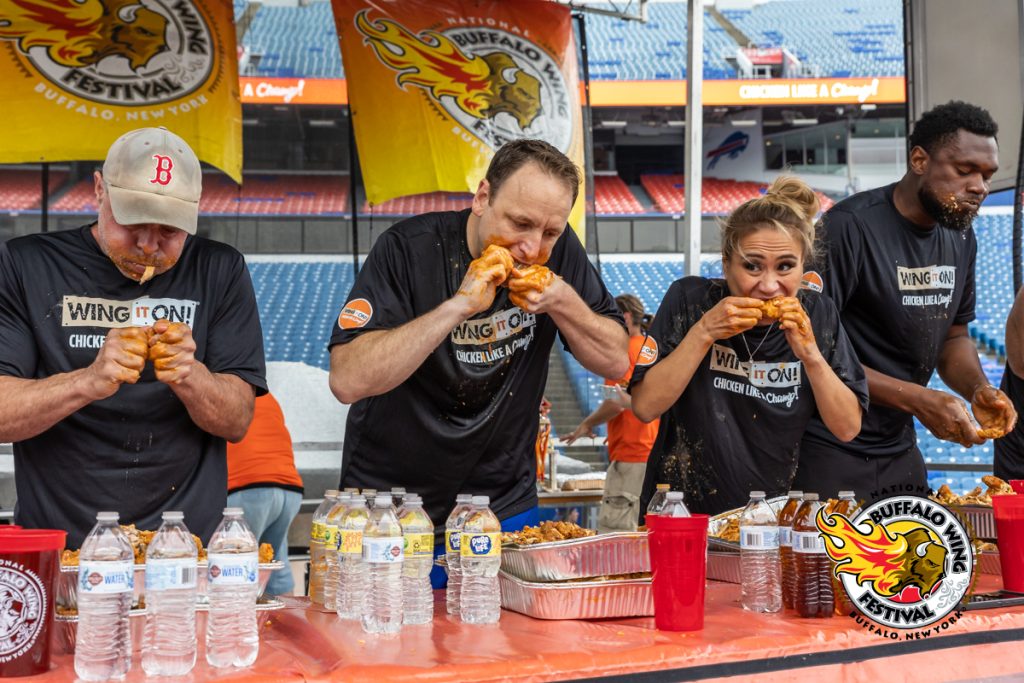 People participating in an eating competition at the Buffalo Wing Festival 