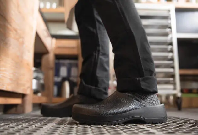 A chef wearing Crocs in a restaurant