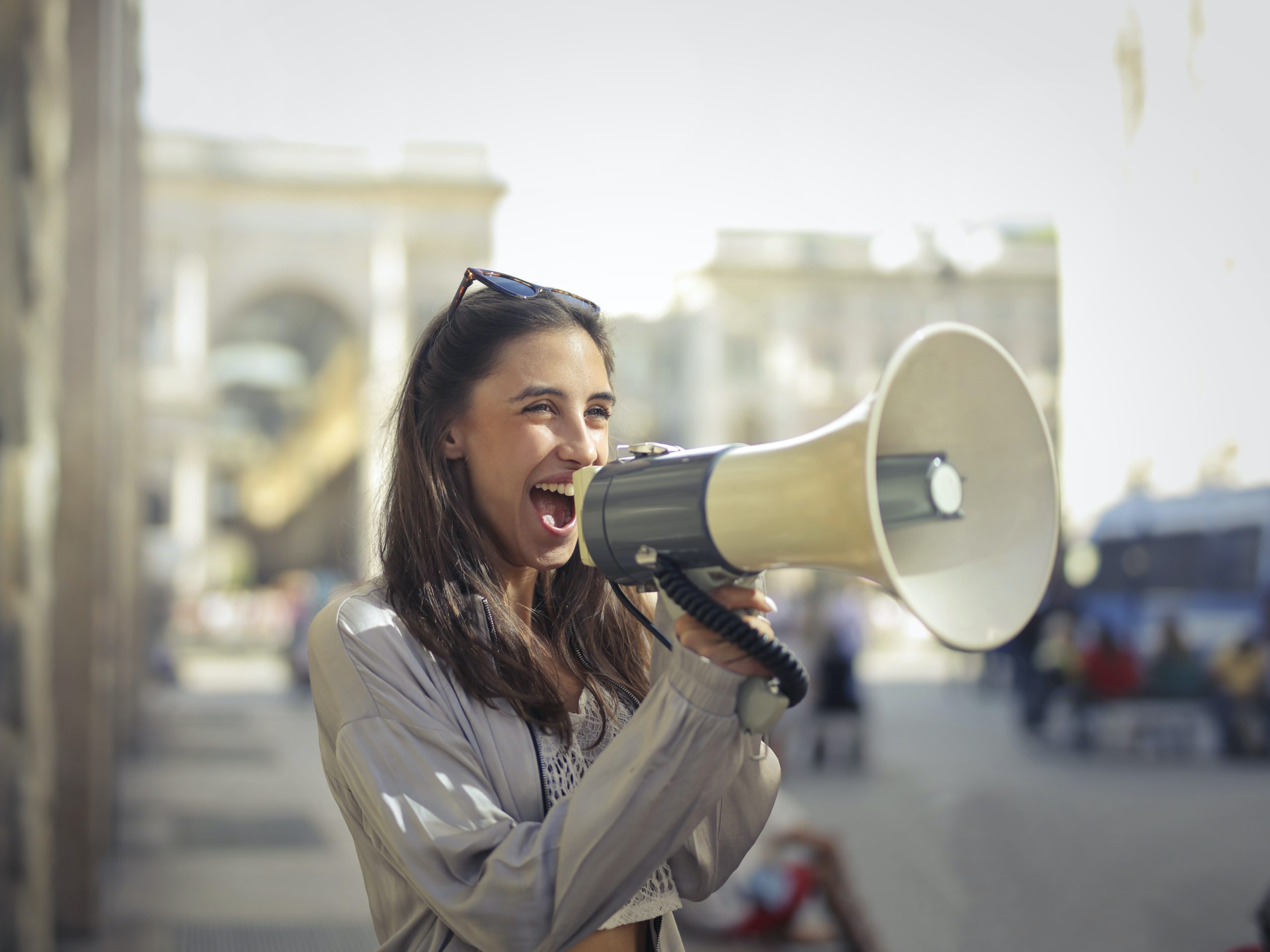 A girl shouting in a mic to promote their business