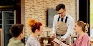 10 Intangible Factors Influencing The Customer Experience And Retention At A Restaurant Restaurant staff attending customers at a table