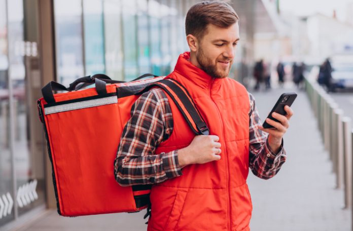 Food Delivery Executive using mobile phone