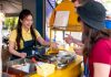 How To Open A Food Cart Business In India In 2023 Woman serving customers at a food cart