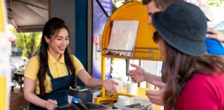 How To Open A Food Cart Business In India In 2023 Woman serving customers at a food cart