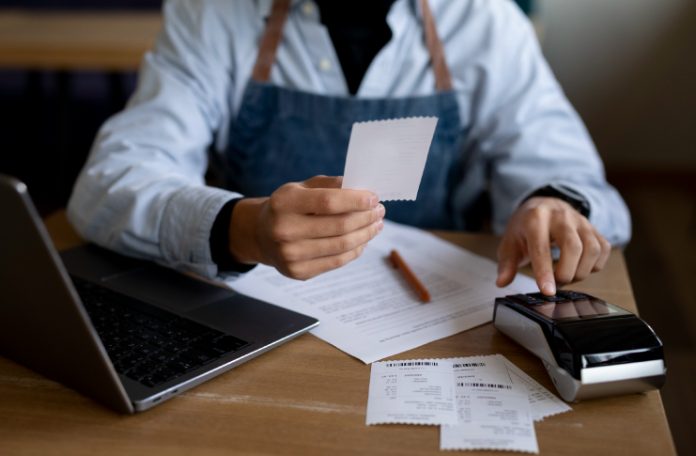 Restaurant Staff holding a bill receipt