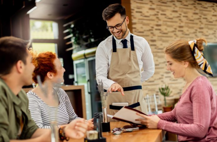 Restaurant staff attending the customers with a smile