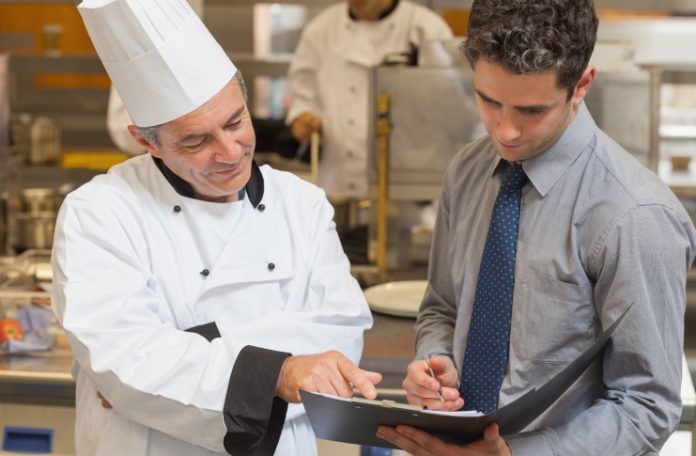 Restaurant manager and chef doing inventory audit