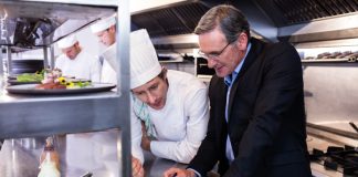 7 Pro Tips To Keep Restaurant Food Costs Under Control Restaurant manager and chef calculating the food costs