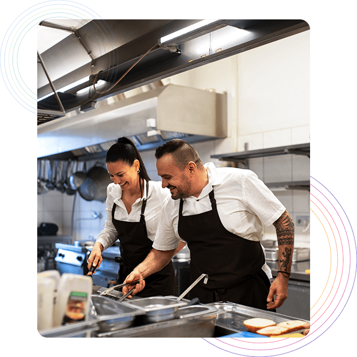 Two chefs preparing food in a restaurant kitchen