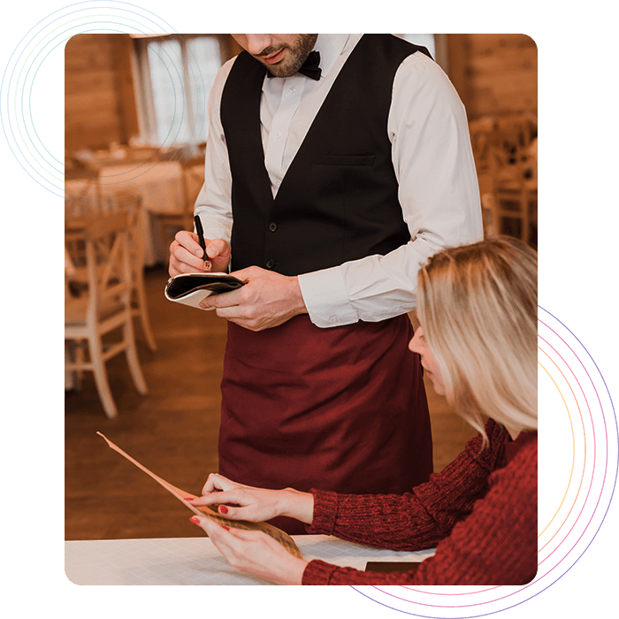 Waiter taking order from a customer on a notepad