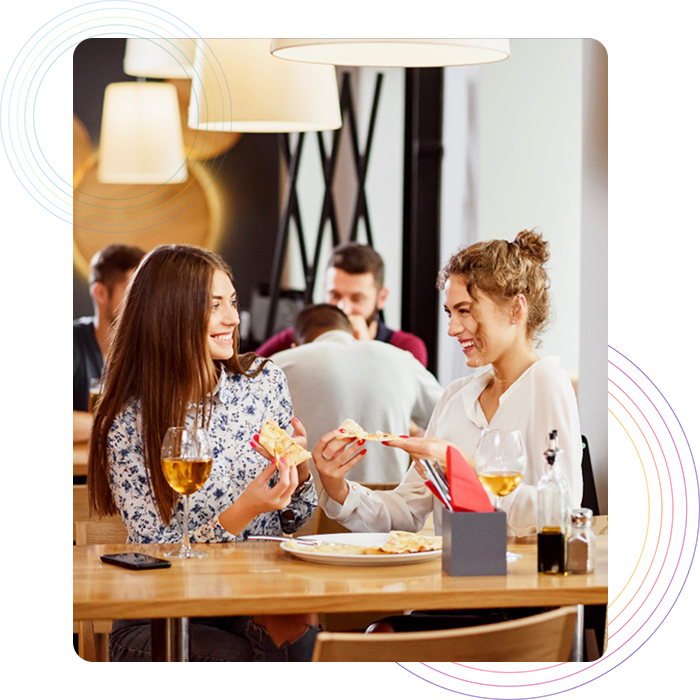 Two women having their meal and drinks in a fast casual restaurant