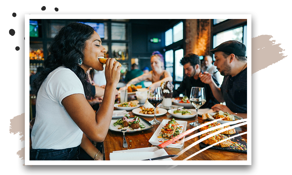 Customers enjoying their meals and drinks in a fine dine restaurant